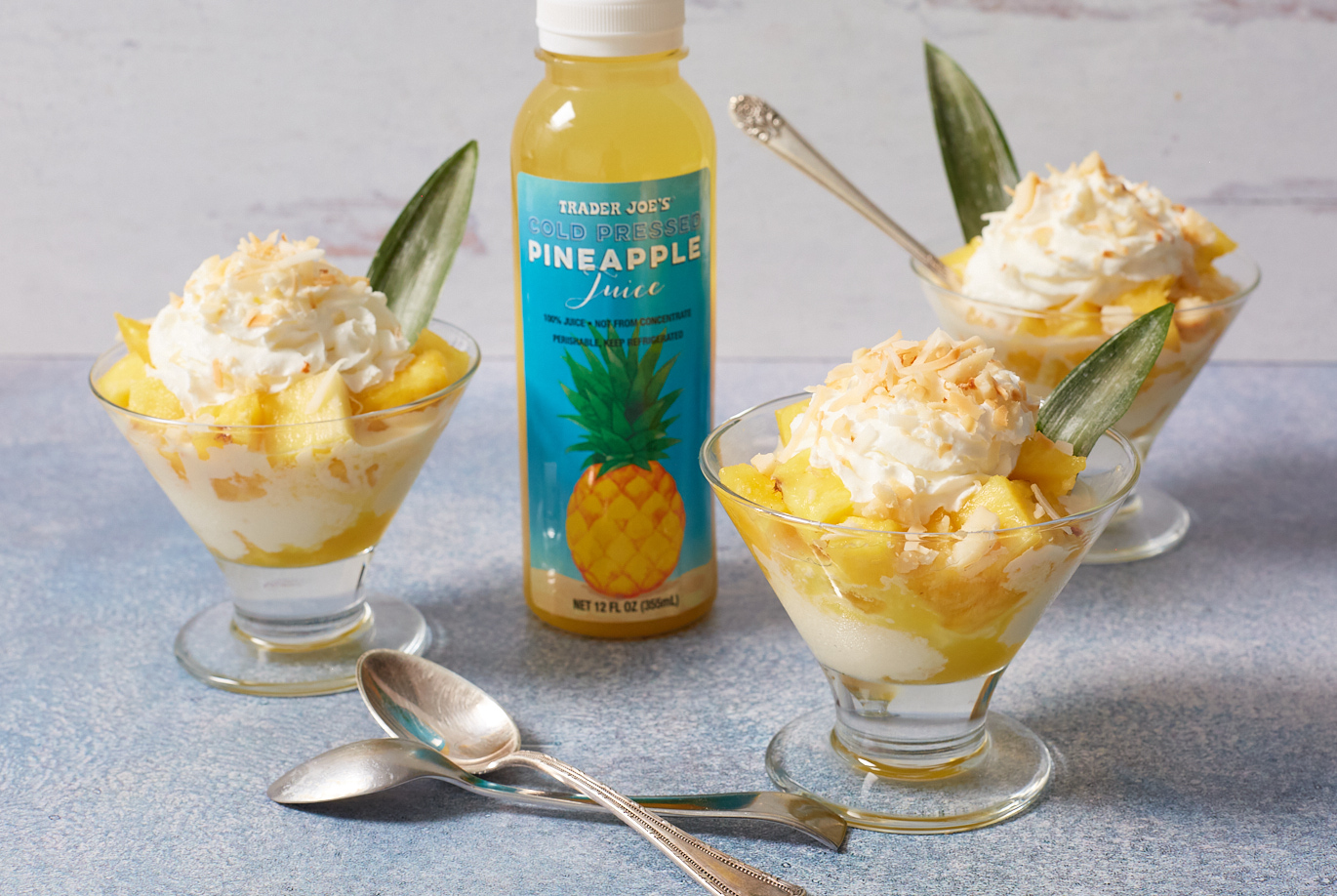 Trader Joe's Cold Pressed Pineapple Juice; used in recipe for Pineapple Parfait - in 3 dessert glasses with pineapple chunks, ice cream, whipped cream, toasted coconut flakes and macadamia nuts