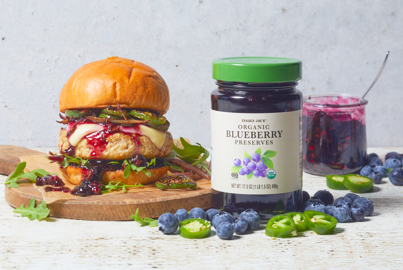 Trader Joe's Organic Blueberry Preserves; topped on a turkey burger with muenster cheese, hot & sweet jalapeño slices and a brioche bun; fresh blueberries and slices of jalapeño on surface